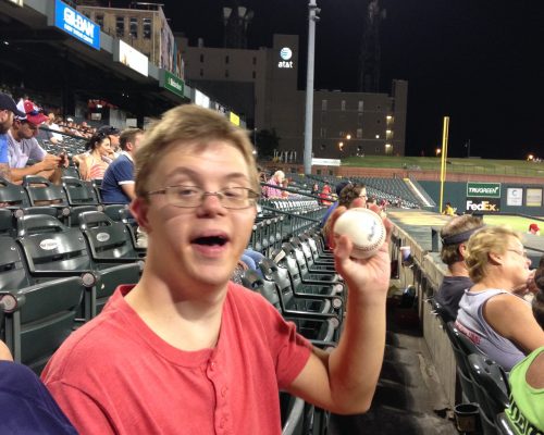 Gabriel Homes resident holding a baseball from a Memphis Redbirds game. Gabriel Homes resident holding a baseball from a Memphis Redbirds game.
