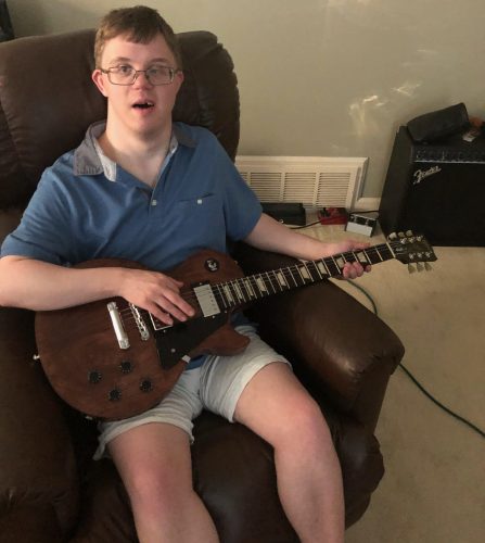 Gabriel Homes resident playing guitar. Gabriel Homes resident playing guitar.