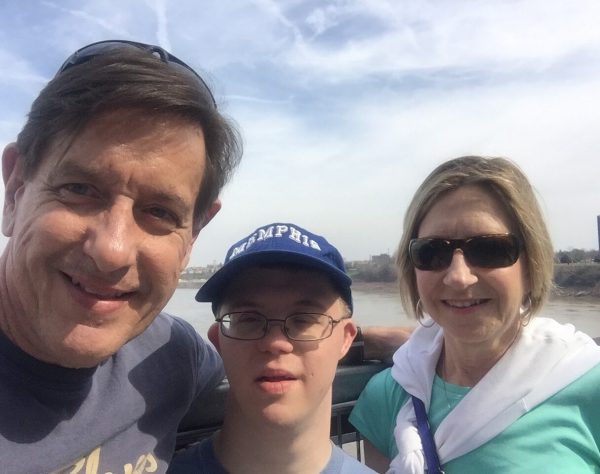 Gabriel Homes resident (center) with parents in front of Memphis skyline.