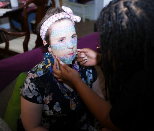 Gabriel Homes resident (left) having a face mask placed on them by staff (right).