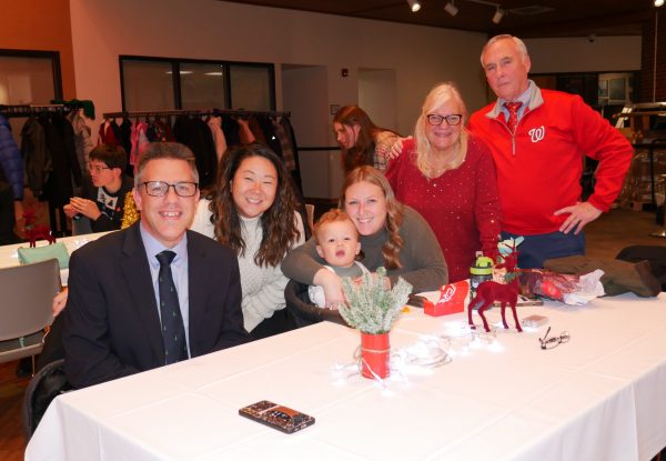 Gabriel Homes resident (left) and his family at the 2024 Christmas party.