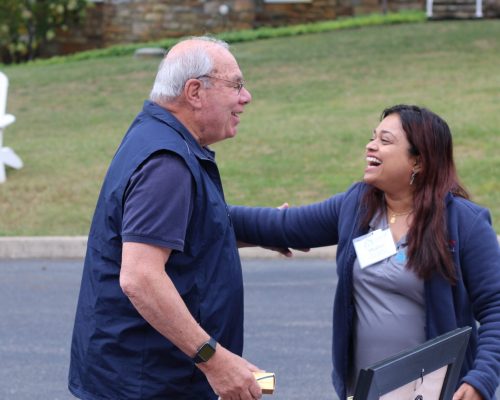 Shalini Kapur (right), director of the development committee on the Gabriel Homes Board of Directors, with Monsignor Bob Cilinski (left). Kapur says friendships with the staff and board have helped everyone more effectively achieve Gabriel Homes' mission.