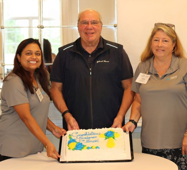 Monsignor Bob Cilinski (center) with cake at Gabriel Homes Golf Tournament.