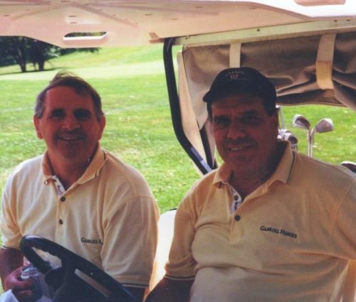 Father Gerry Creedon (left) with Monsignor Bob Cilinski (right) in a golf cart at the Gabriel Homes Annual Golf Tournament.