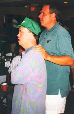 Then-Father Bob Cilinski (right) with a Gabriel Homes resident (left).