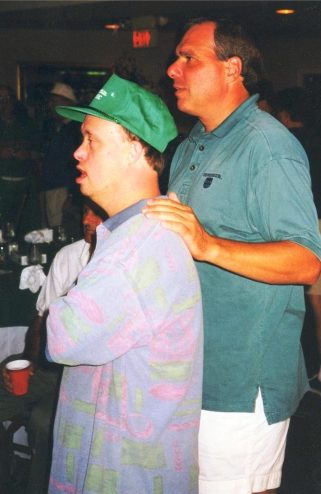 Then-Father Bob Cilinski (right) with a Gabriel Homes resident (left).