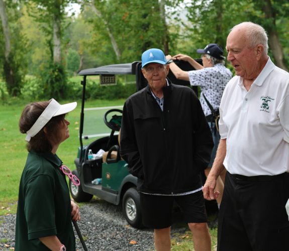 Golfer (right) chatting with Gabriel Homes resident (left).