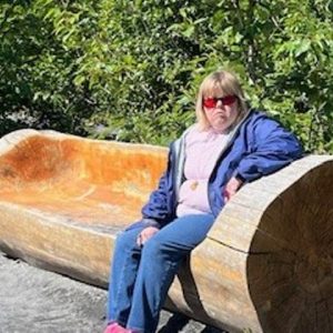 Gabriel Homes resident on log while on vacation.