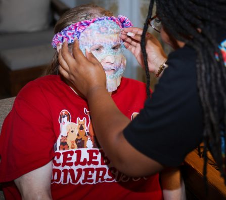 Gabriel Homes resident (left) with a face mask being put on them.